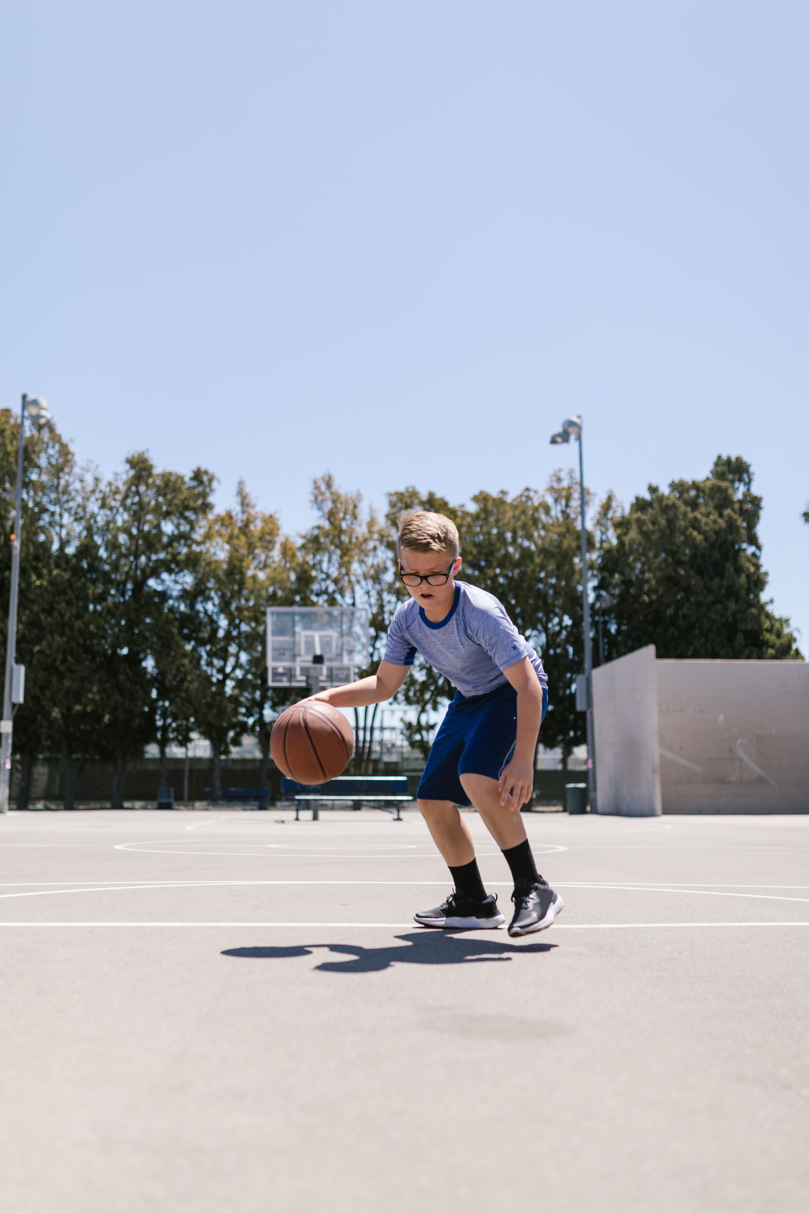 Young player dribbling on a sunny court