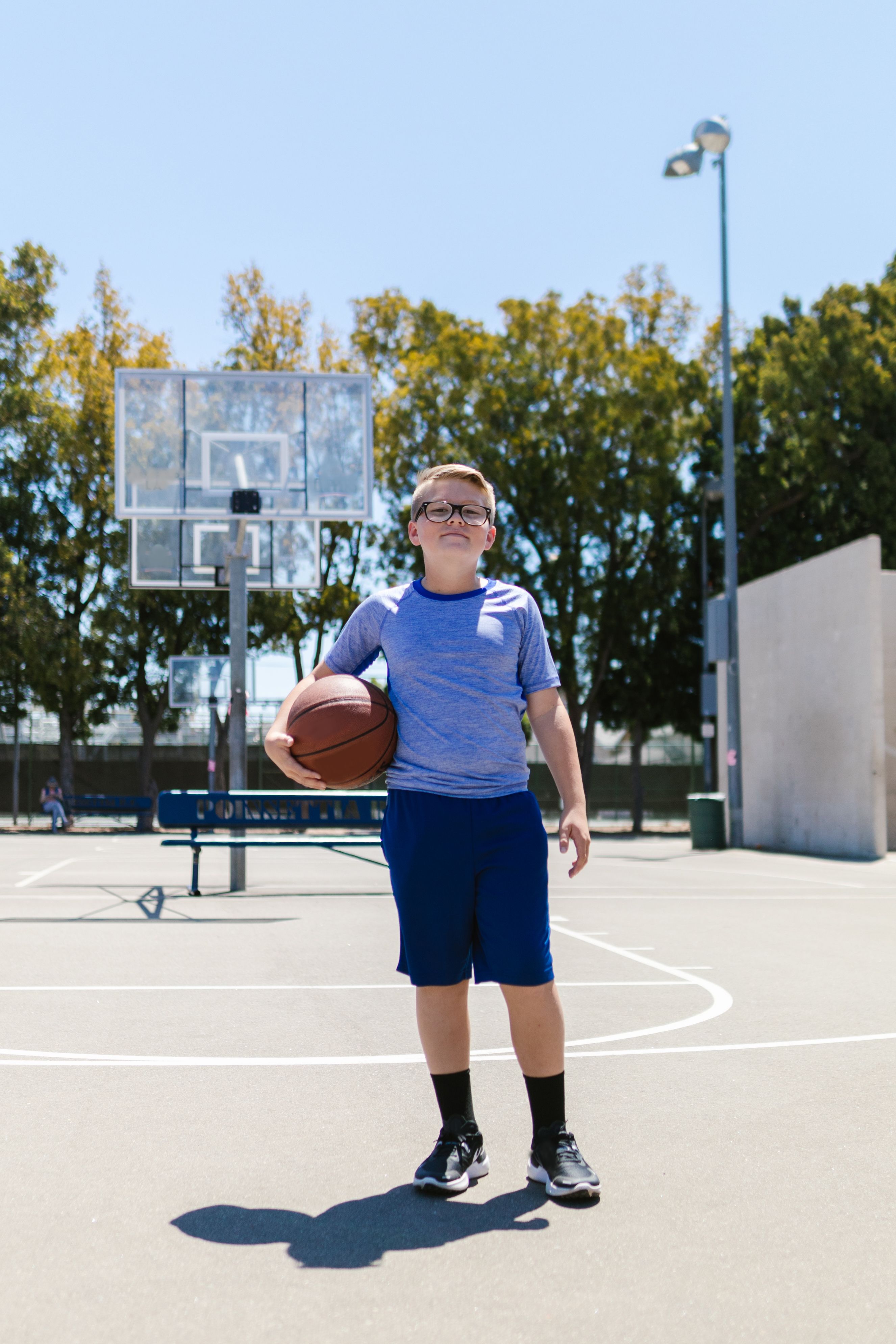 Young player with a basketball on court